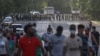 CUBA - Demonstrators walk away from army soldiers blocking a road during a protest against and in support of the government, amidst the coronavirus disease (COVID-19) outbreak, in Havana, Cuba July 11, 2021