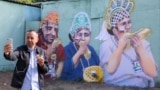 RUSSIA – MOSCOW,JULY 3, 2018: A mural by street artist Alex Melentyev depicting Inna Kalenskaya, her husband Dmitry Gnatyuk and nephew Yuri Gnatyuk, football fans who wore kokoshniks [traditional Russian headdress] and had a snack during the 2018 FIFA Wo