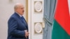 Belarusian President Alexander Lukashenko walks before a press conference in Minsk